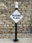 A lozenge shaped road sign for Passing Place, post mounted.