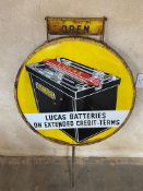 A Lucas Batteries circular enamel sign, in a garage forecourt spinning frame, with open/closed