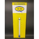 A Duckham's 20-50 Motor Oil enamel thermometer sign, 13 x 36".