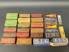 A selection of empty spark plug tins including Sphinx and Lodge, plus various empty cardboard plug