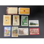 A selection of playing cards all with advertising, including Davies tyres and Raleigh, plus some