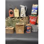 A collection of assorted cans including three jerry fuel cans and also a fire bucket.