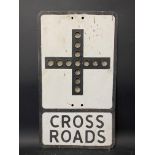 A metal road sign for Cross Roads, with integral glass reflective discs, 12 x 21".