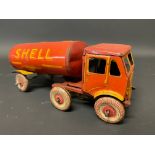 A clockwork tinplate model of an articulated petrol tanker in Shell BP livery.