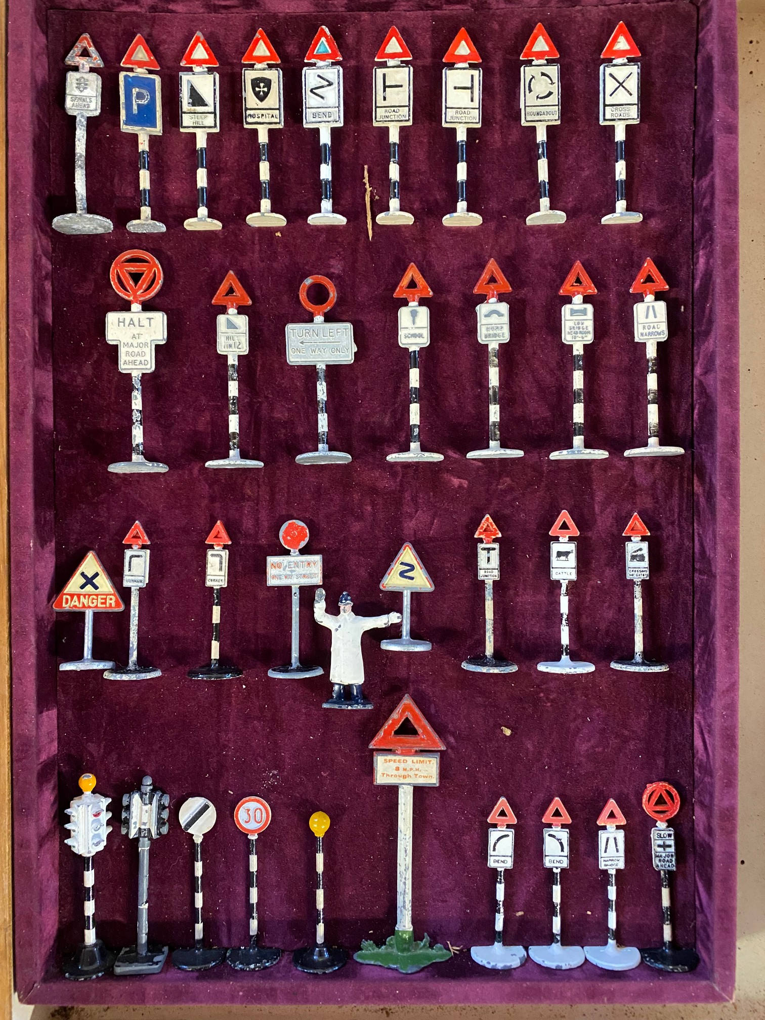 A framed collection of die-cast miniature road signs.