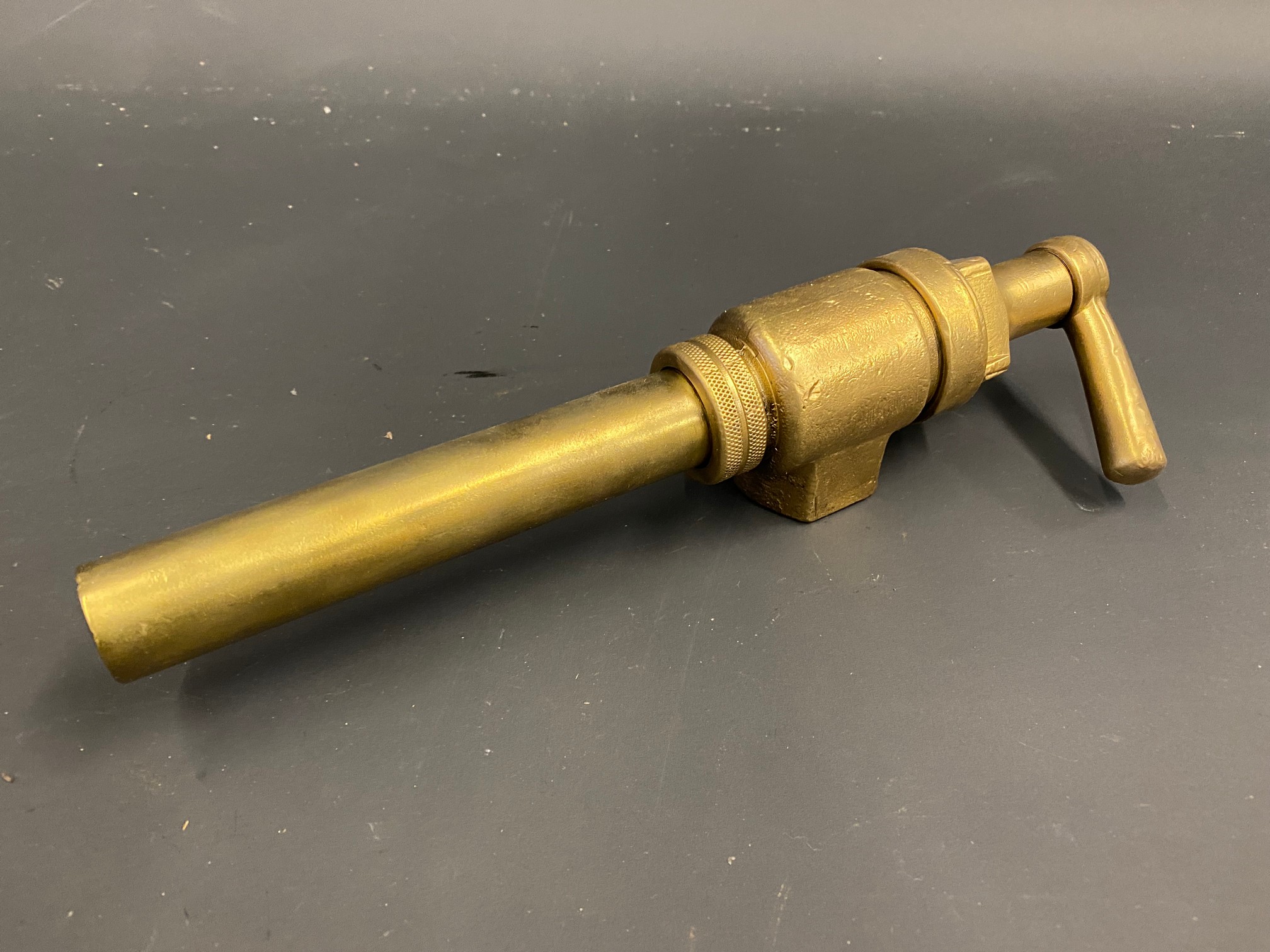 A bronze petrol pump trigger nozzle.