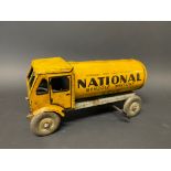 A clockwork tinplate model of a petrol tanker in National Benzole Mixture livery.