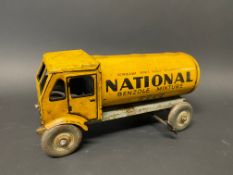 A clockwork tinplate model of a petrol tanker in National Benzole Mixture livery.