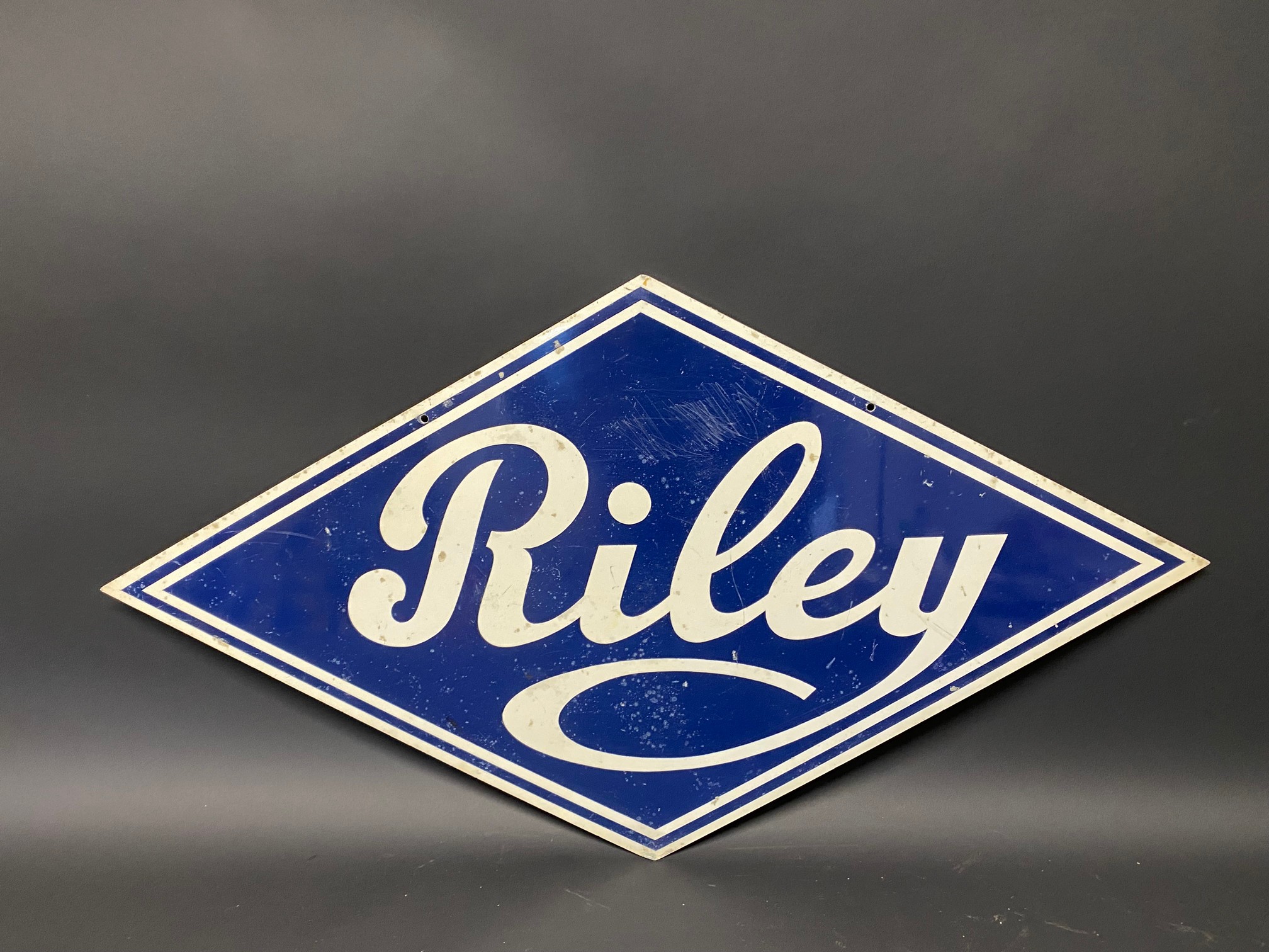 A Riley lozenge shaped double sided aluminium advertising sign, 27 x 14 ...