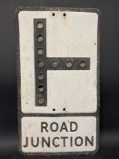 A metal road sign for Road Junction, with integral reflective discs, 12 x 21".