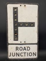 A metal road sign for Road Junction, with integral reflective discs, 12 x 21".