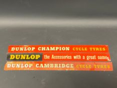 Three Dunlop shelf mounted advertising strips.