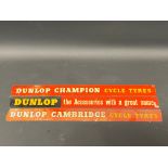 Three Dunlop shelf mounted advertising strips.