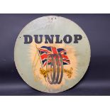 A Dunlop 'As British as the flag' circular cardboard advertising sign, 24" diameter.
