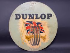 A Dunlop 'As British as the flag' circular cardboard advertising sign, 24" diameter.