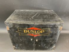 A Dunlop counter top two door dispensing cabinet with advertising to the front and inside, also