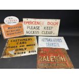 Five assorted garage signs, including Raleigh bicycles.