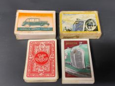 Two packs of Austin playing cards, a pack advertising Wolseley and another for RAC.