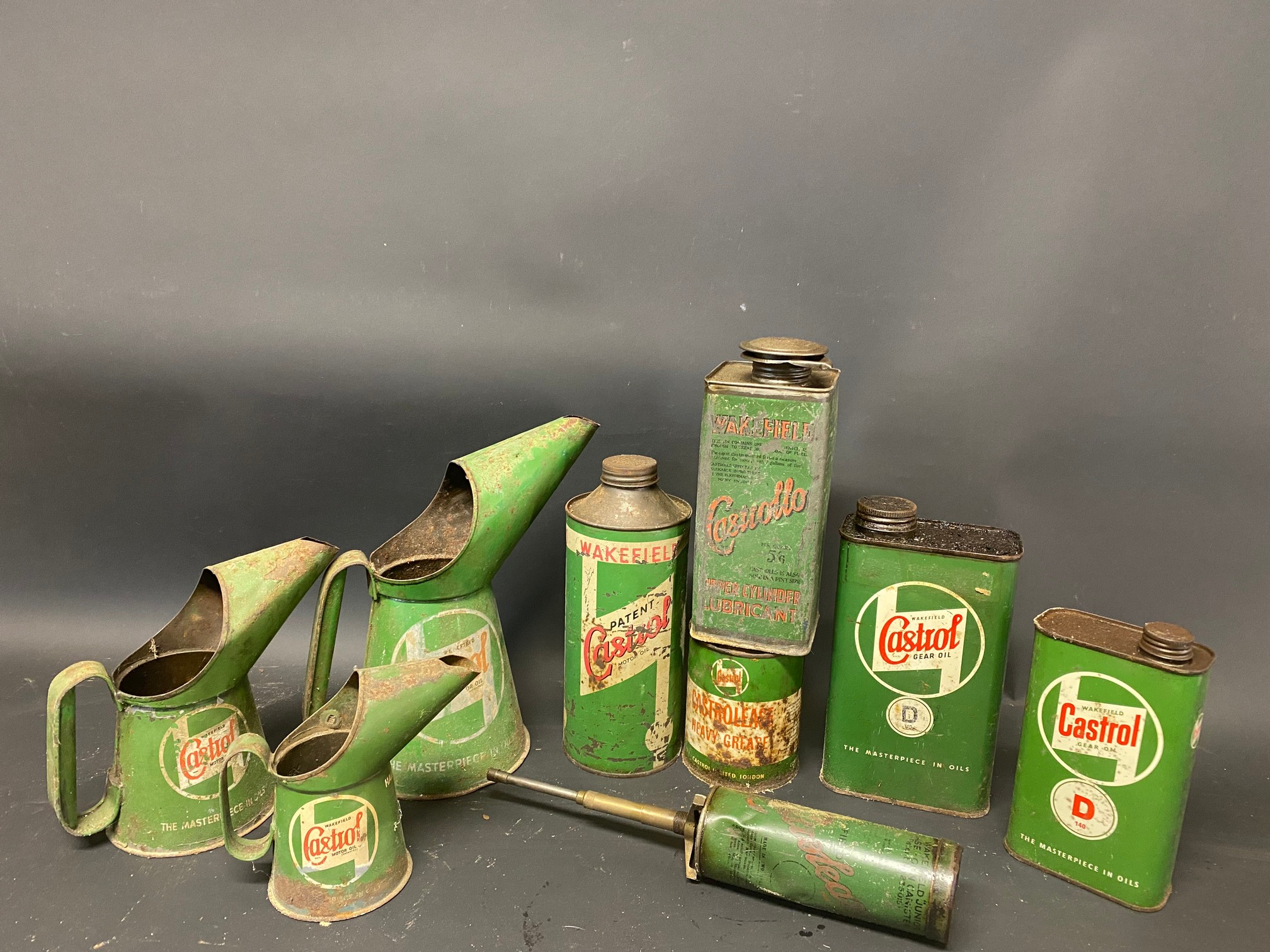 A quantity of Castrol oil cans and measures.