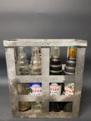 An Essolube eight division oil bottle crate containing three quart Esso Extra bottles, three quart