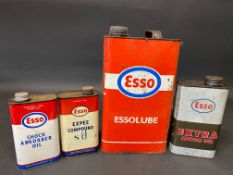 Four assorted Esso oil cans.