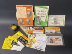 A selection of Dunlop blotting cards, a Dunlop branded hole punch, a small group of Dunlop tins