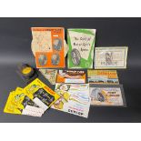 A selection of Dunlop blotting cards, a Dunlop branded hole punch, a small group of Dunlop tins