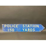 A single sided directional sign 'Police Station 150 Yards', with reflective lettering, 32 3/4 x 6".