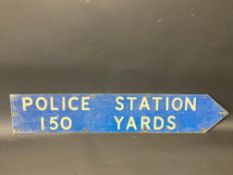 A single sided directional sign 'Police Station 150 Yards', with reflective lettering, 32 3/4 x 6".