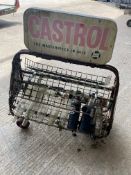 A double sided Castol garage forecourt oil bottle rack with an assortment of oil bottles.