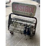 A double sided Castol garage forecourt oil bottle rack with an assortment of oil bottles.