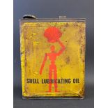 A Shell Lubricating Oil rectangular gallon can with robot/stick man motifs.