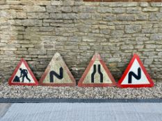 Four triangular road signs.