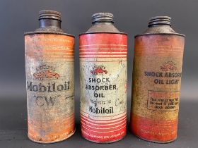 Three Gargoyle Mobiloil cylindrical quart cans.