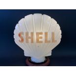 A Shell glass petrol pump globe by Hailware, fully stamped underneath.