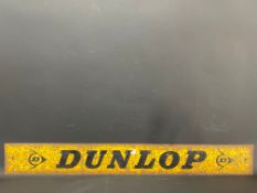 A narrow metal sign advertising Dunlop, possibly from a rack, 48 x 6".