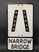 A metal road sign for Narrow Bridge with integral glass reflectors, 12 x 21".