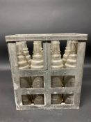 An Essolube eight division oil bottle crate containing a full set of Essolube quart bottles.