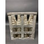 An Essolube eight division oil bottle crate containing a full set of Essolube quart bottles.