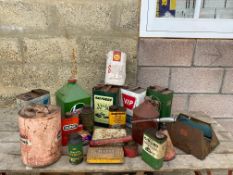 Two boxes of assorted oil cans including a VIP gallon can.