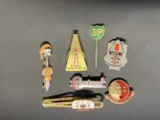 A Shell brass lapel badge, with robot/stick man motif, a Redline Super badge and four others.