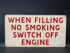 A garage forecourt pressed metal sign 'When Filling No Smoking...', 23 x 12".