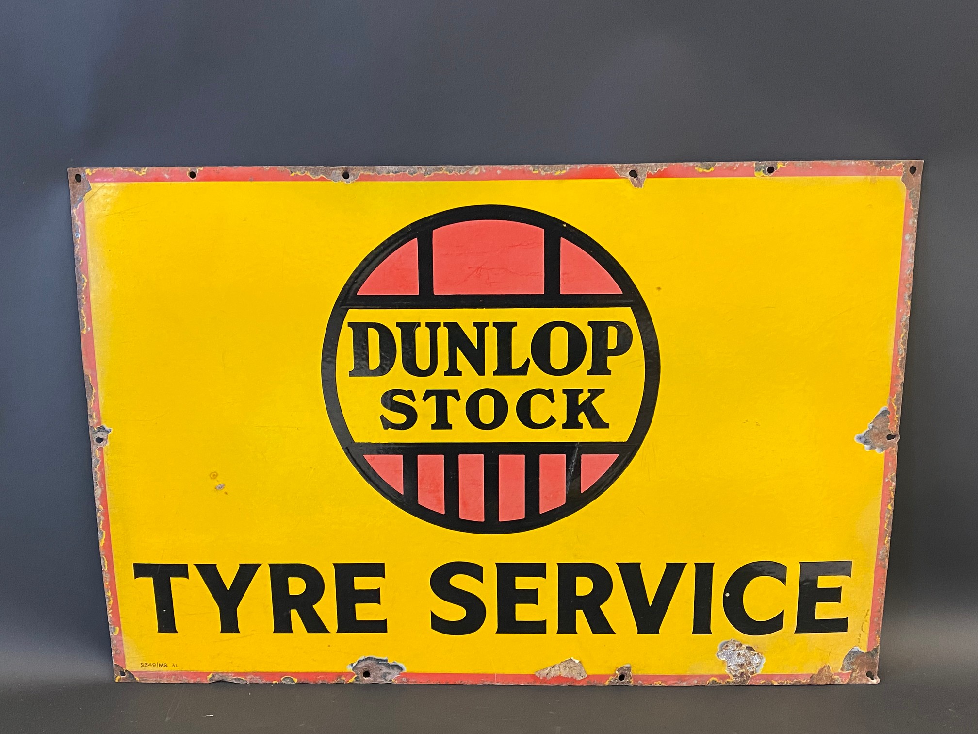 A Dunlop Stock Tyre Service rectangular enamel sign, 30 x 20".