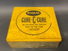 A Romac Cure-C-Cure lidded counter top dispensing tin, with partial contents.