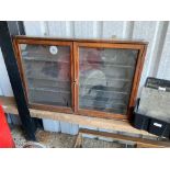 An Edwardian mahogany and stained pine wall mounted two door display cabinet, with adjustable