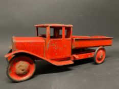 A large tinplate model of a tipping truck, probably a Ford Model AA.