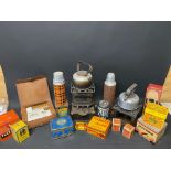 Three boxes of camping stoves, picnic accessories, packaging, tins etc.