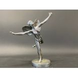 A chrome plated accessory mascot in the form of a scantily clad winged lady standing on one leg.