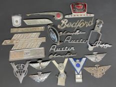 A selection of car insignia and badges including Fordson Major, Austin etc.