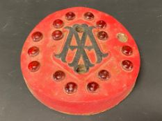 An unusual AA cast iron marker with inset red glass reflective beads.